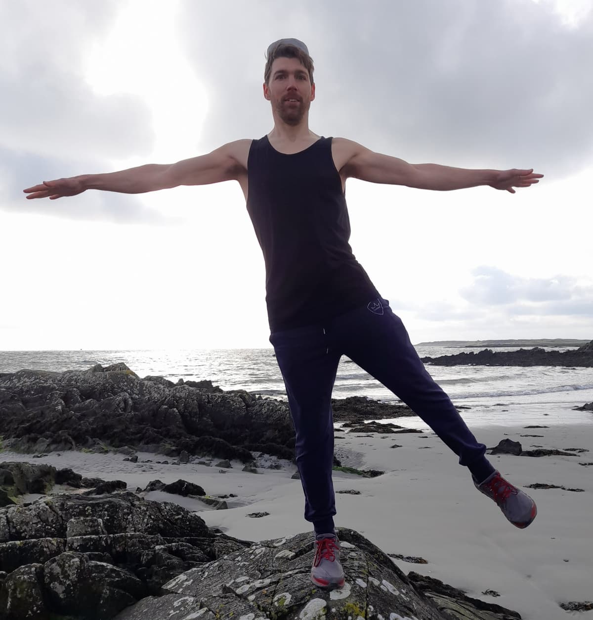 Vince demonstrating PosturePrime Vertex on the beach
